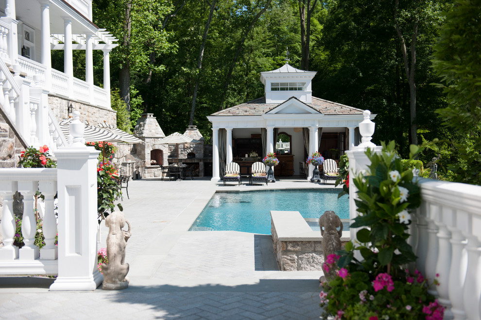 Inspiration for a large traditional backyard custom-shaped pool in New York with a pool house.