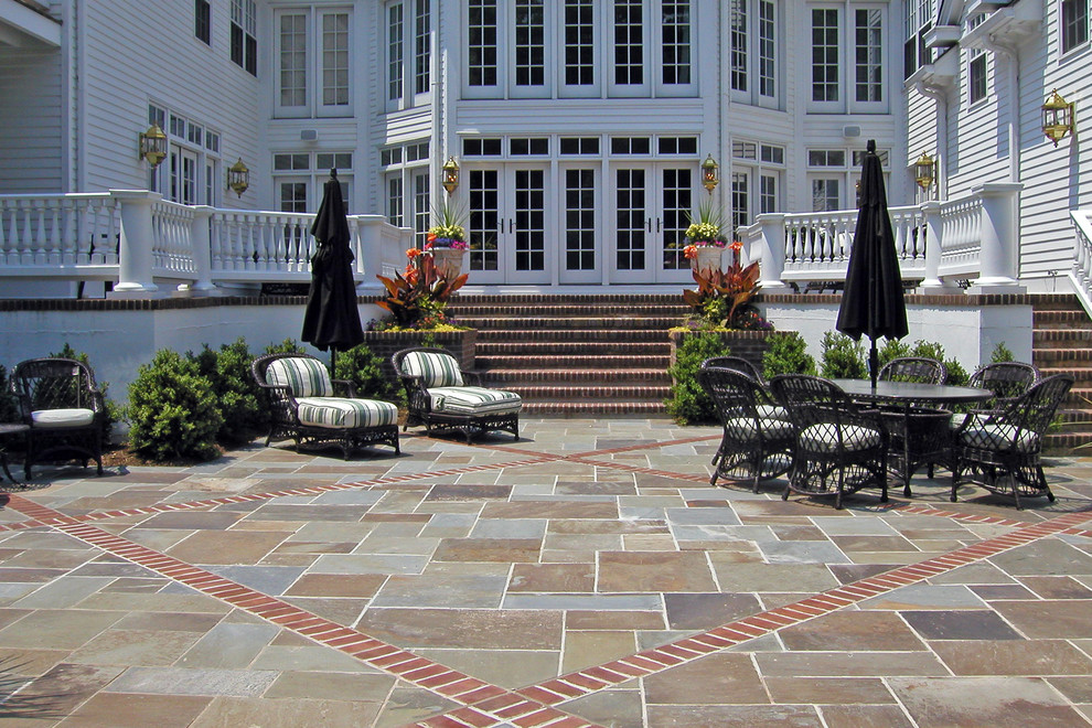 Photo of an expansive traditional backyard patio in New York with no cover and tile.