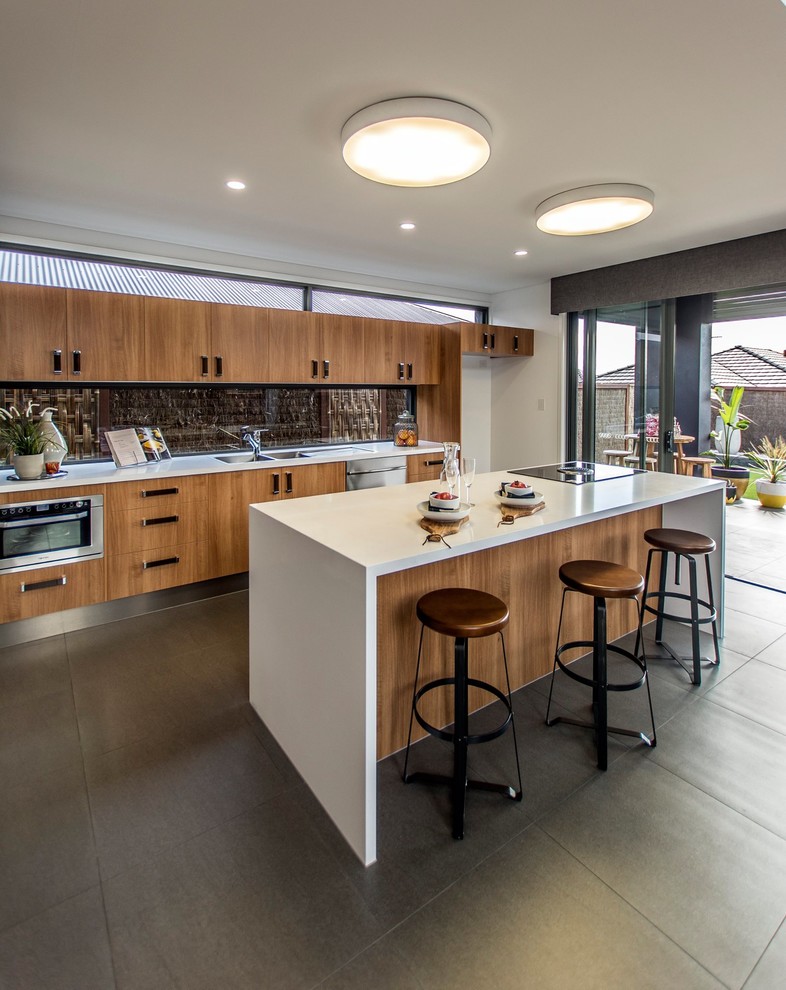 Contemporary kitchen in Brisbane with flat-panel cabinets, medium wood cabinets, brown splashback, stainless steel appliances and with island.