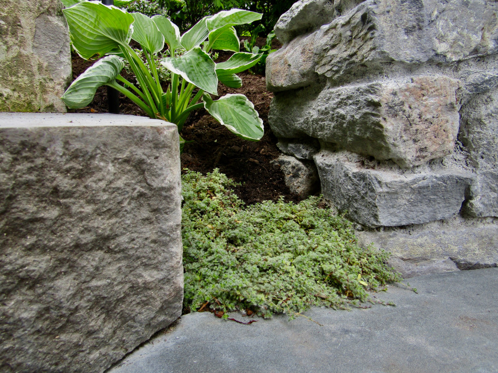 Inspiration for a coastal front partial sun garden in Vancouver with a flowerbed and natural stone paving.