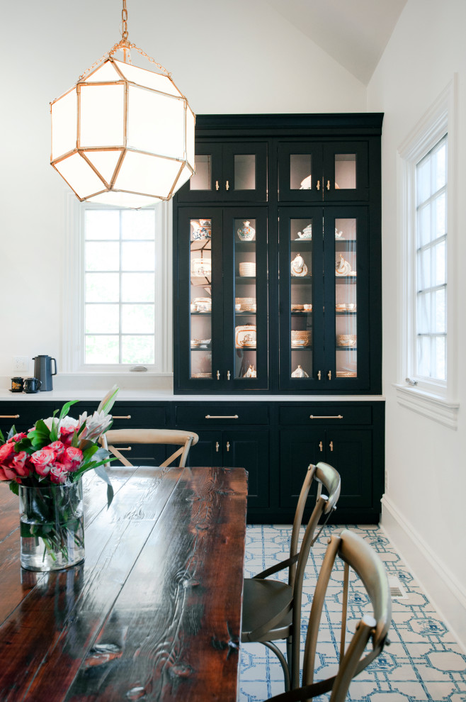 Photo of an expansive eclectic u-shaped eat-in kitchen in Nashville with a farmhouse sink, beaded inset cabinets, black cabinets, quartz benchtops, white splashback, ceramic splashback, panelled appliances, painted wood floors, with island, blue floor and white benchtop.