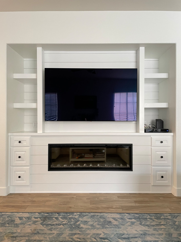 Medium sized traditional open plan games room in Las Vegas with white walls, porcelain flooring, a ribbon fireplace, a timber clad chimney breast, beige floors, tongue and groove walls and a built-in media unit.