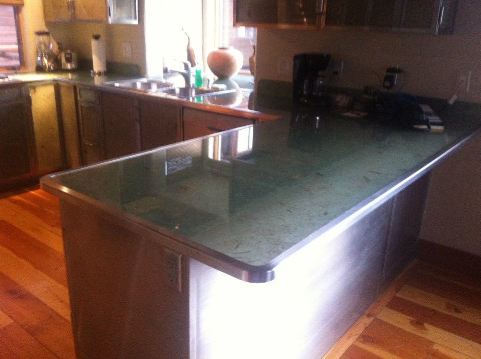 Mid-sized transitional u-shaped medium tone wood floor and brown floor kitchen photo with a double-bowl sink, stainless steel appliances and a peninsula