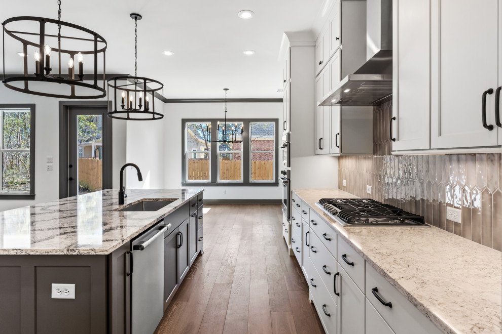 Mid-sized transitional l-shaped medium tone wood floor and brown floor open concept kitchen photo with an undermount sink, recessed-panel cabinets, white cabinets, quartz countertops, beige backsplash, ceramic backsplash, stainless steel appliances, an island and beige countertops
