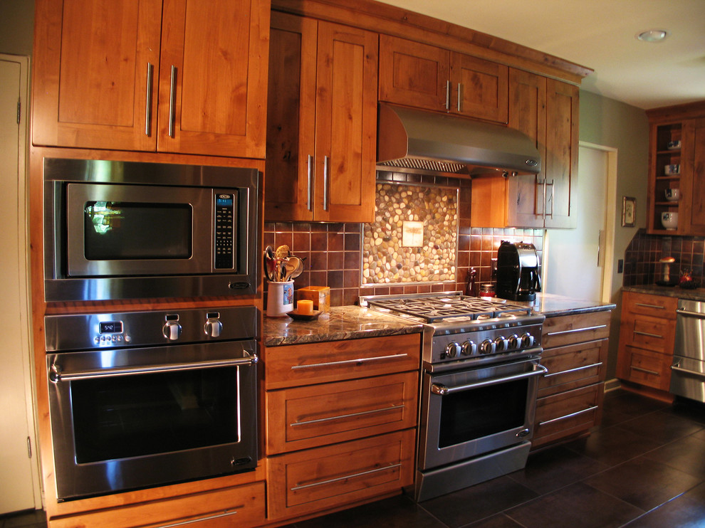 Eat-in kitchen - large transitional u-shaped eat-in kitchen idea in New Orleans with a double-bowl sink, medium tone wood cabinets, marble countertops, brown backsplash, ceramic backsplash, stainless steel appliances and no island