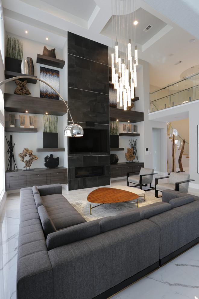 Inspiration for an expansive modern formal open plan living room in Houston with white walls, a standard fireplace, a tiled fireplace surround, a wall mounted tv, white floors and a drop ceiling.