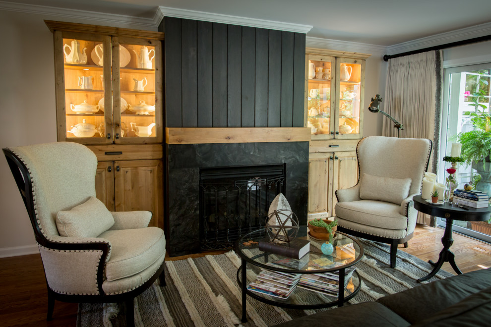Inspiration for a large rustic open concept and l-shaped light wood floor and brown floor eat-in kitchen remodel with white walls, a wood stove, a stone fireplace, an undermount sink, recessed-panel cabinets, dark wood cabinets, quartz countertops, white backsplash, quartz backsplash, stainless steel appliances, an island and white countertops