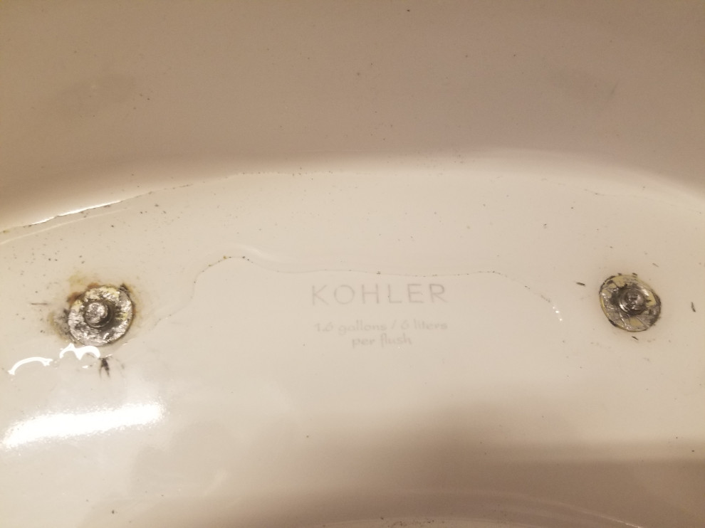 How can I remove a broken and stuck bolt from a toilet seat?
