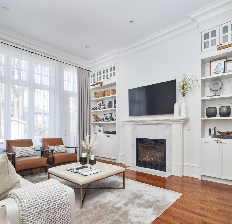 Inspiration for a mid-sized country formal open concept living room in Toronto with white walls, medium hardwood floors, a standard fireplace, a wood fireplace surround, brown floor, a wall-mounted tv and planked wall panelling.