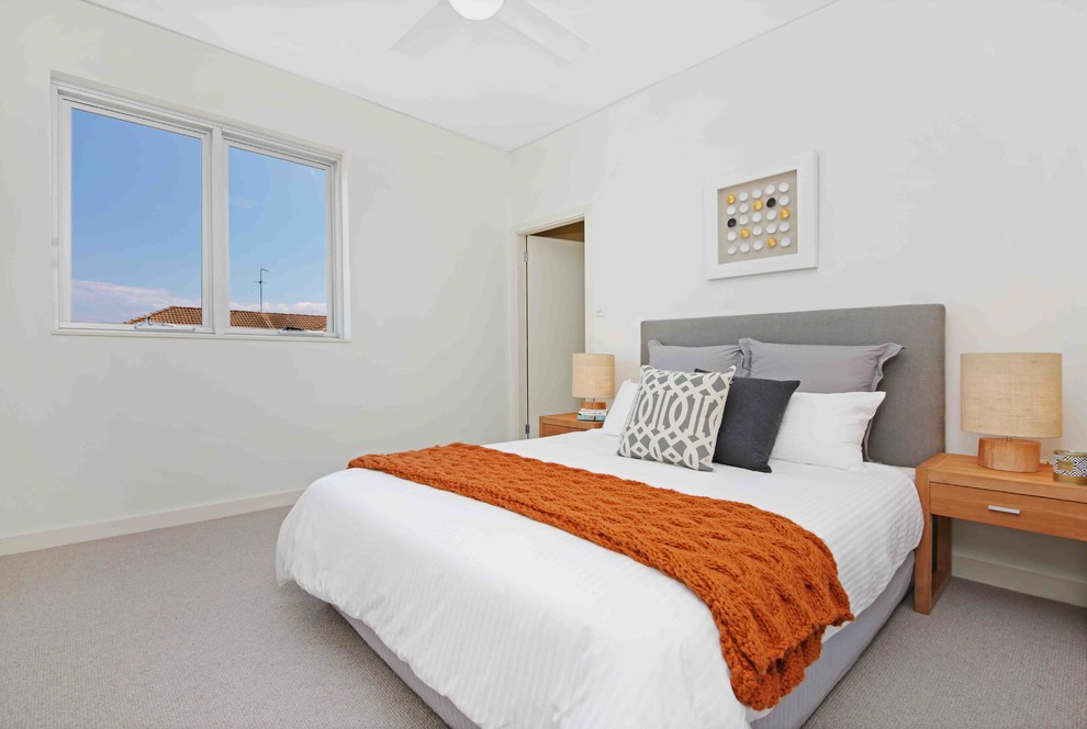 Contemporary bedroom in Sydney with white walls, carpet and no fireplace.