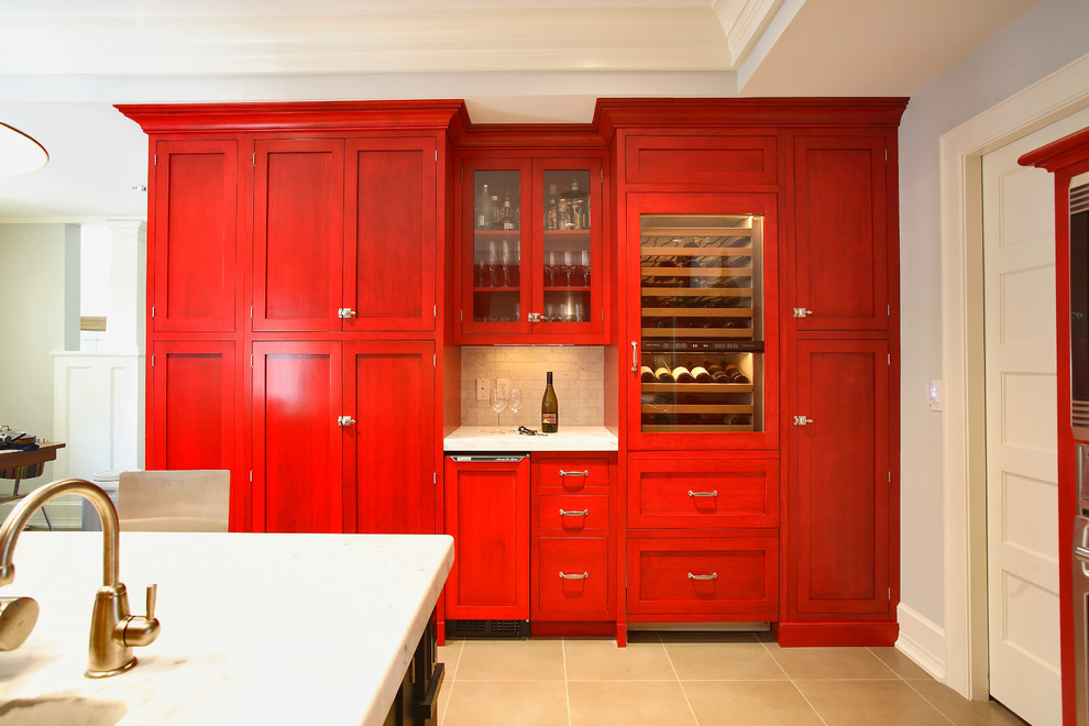 Mid-sized transitional l-shaped kitchen pantry in New York with shaker cabinets, red cabinets, marble benchtops, ceramic floors, with island, an undermount sink, grey splashback, subway tile splashback, stainless steel appliances and brown floor.