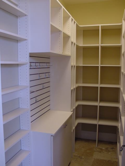 Mid-sized contemporary walk-in wardrobe in Orlando with white cabinets.