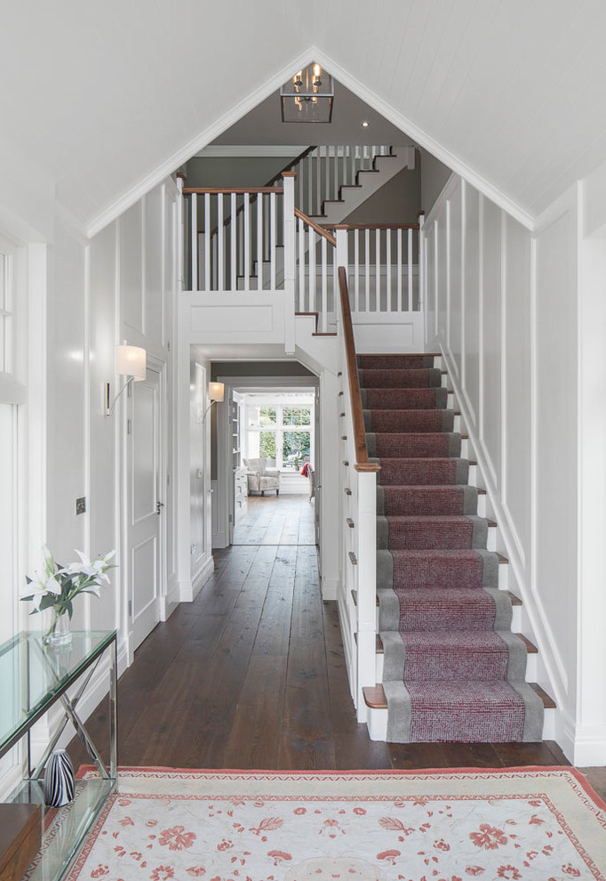 Design ideas for a small transitional wood l-shaped staircase in Dublin with wood risers and wood railing.