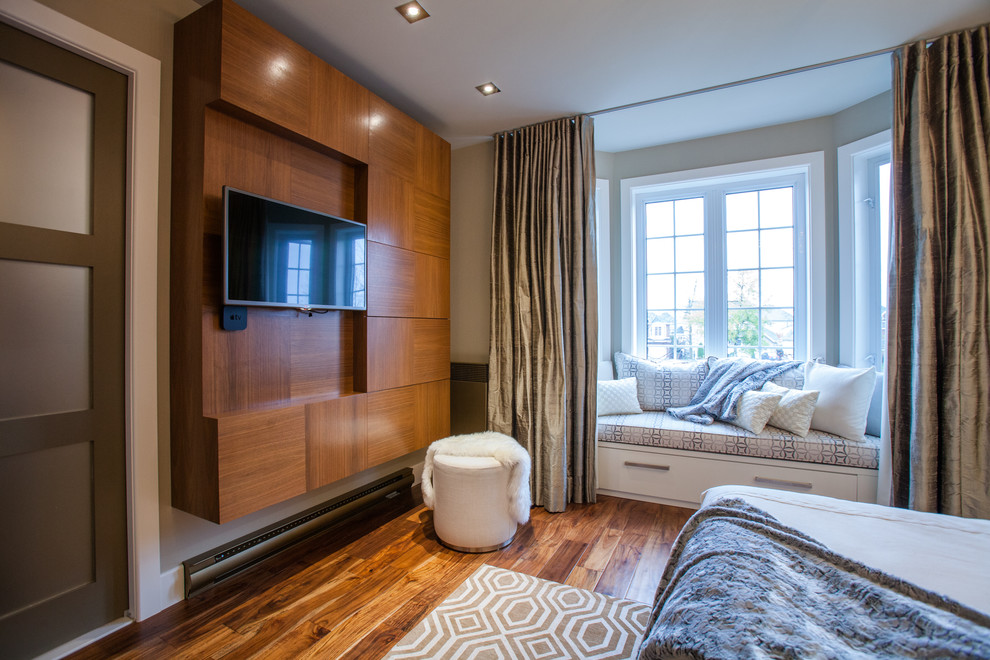 Photo of a large contemporary master bedroom in Montreal with beige walls, medium hardwood flooring and no fireplace.