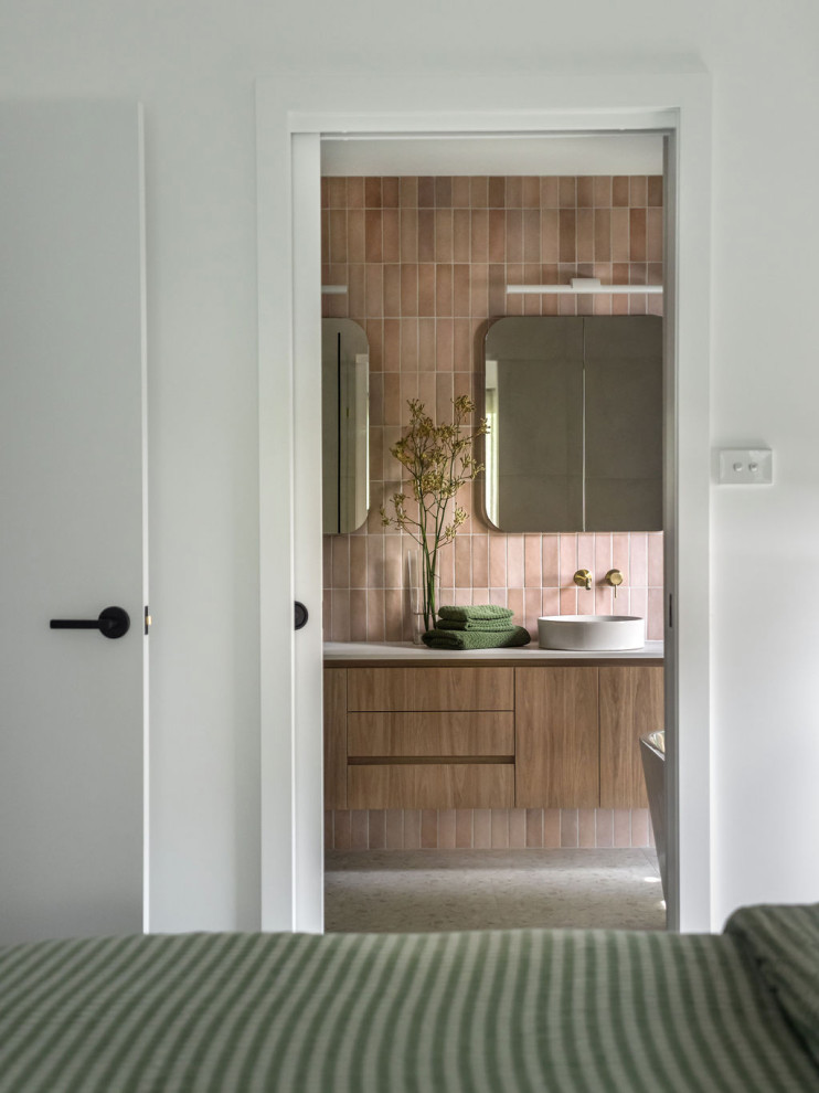 Design ideas for a large contemporary master bathroom in Melbourne with a corner tub, an open shower, a one-piece toilet, pink tile, ceramic tile, white walls, porcelain floors, a vessel sink, solid surface benchtops, grey floor, a sliding shower screen, white benchtops, a niche, a double vanity and a floating vanity.