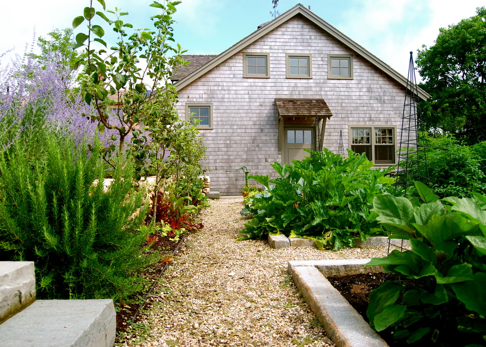 This is an example of a mid-sized country backyard full sun formal garden for summer in Boston with a vegetable garden and gravel.