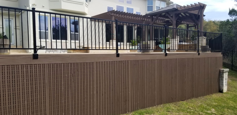 Large transitional backyard deck photo in Austin