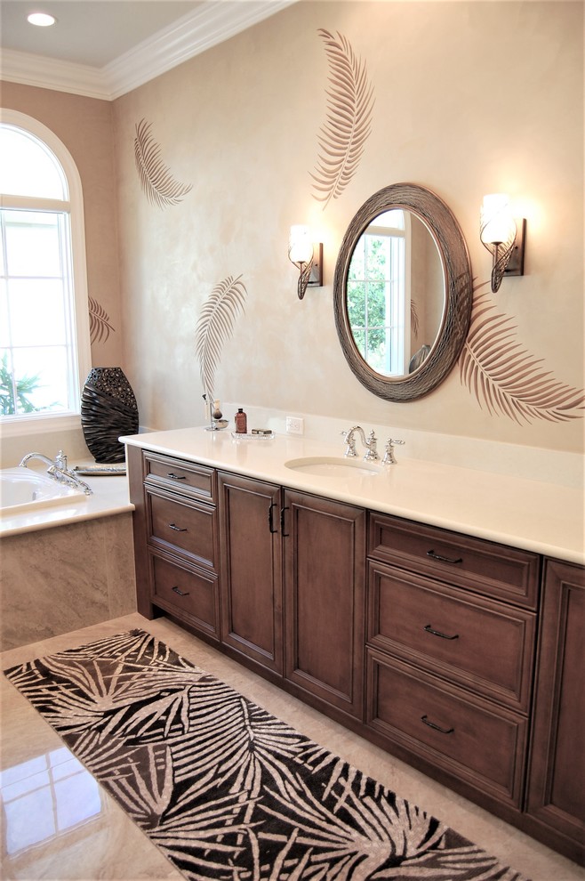 This is an example of a large tropical master bathroom in Tampa with recessed-panel cabinets, a drop-in tub, beige walls, porcelain floors, an undermount sink, wood benchtops, beige floor and beige benchtops.