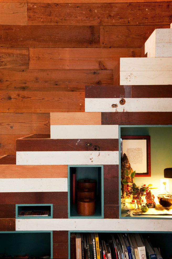 This is an example of a small eclectic wood straight staircase in Austin with painted wood risers.