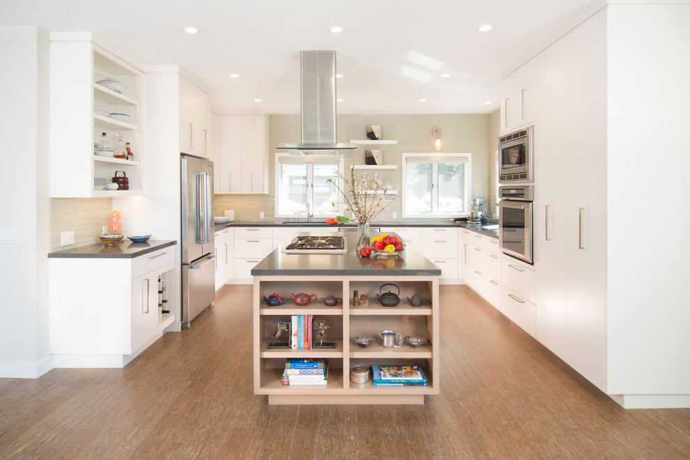 Design ideas for a transitional u-shaped kitchen in San Francisco with an undermount sink, flat-panel cabinets, white cabinets, beige splashback, stainless steel appliances, medium hardwood floors, with island and brown floor.