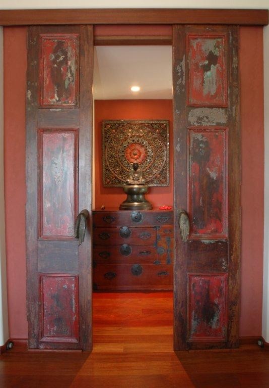 Design ideas for a large asian hallway in San Diego with red walls, dark hardwood floors and brown floor.
