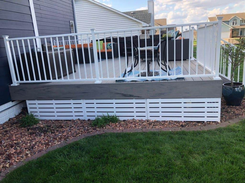 Design ideas for a mid-sized backyard and ground level deck in Other with with skirting, no cover and metal railing.