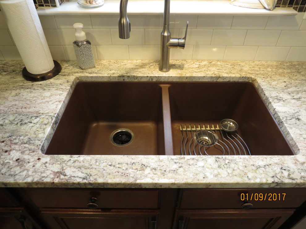 Example of a mid-sized transitional l-shaped ceramic tile eat-in kitchen design with an undermount sink, raised-panel cabinets, distressed cabinets, granite countertops, white backsplash, porcelain backsplash, stainless steel appliances and an island