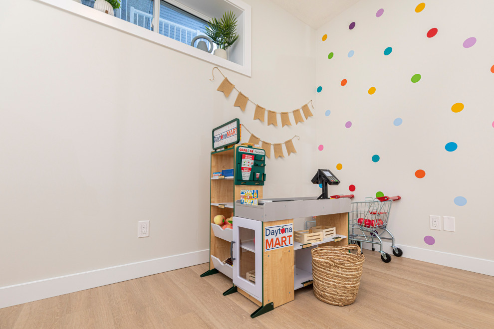 Idée de décoration pour une chambre d'enfant de 1 à 3 ans tradition de taille moyenne avec un mur blanc et sol en stratifié.