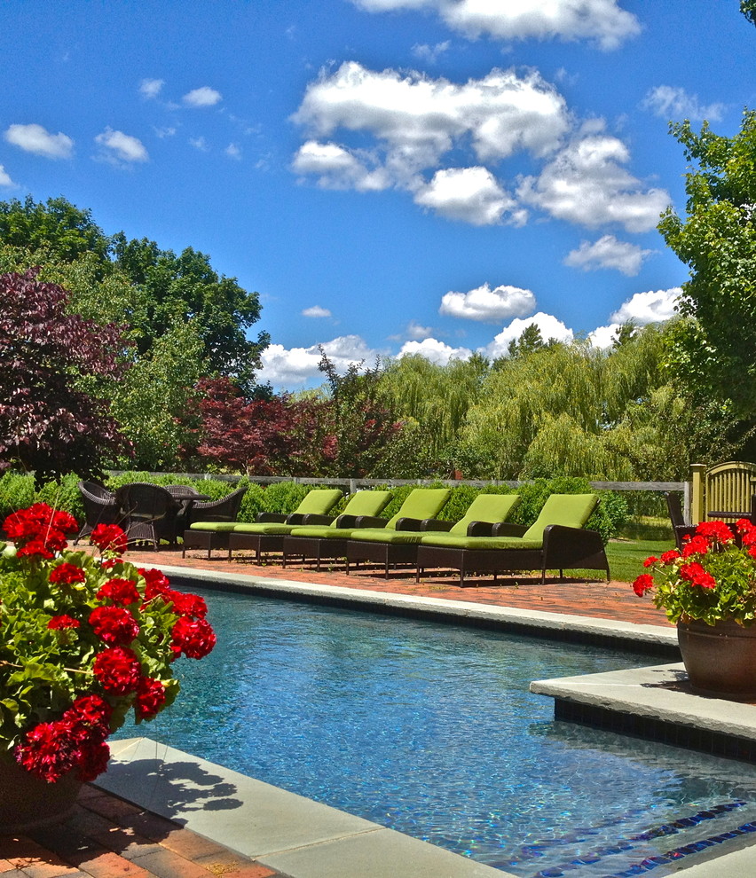 Design ideas for a traditional pool in New York with brick pavers.