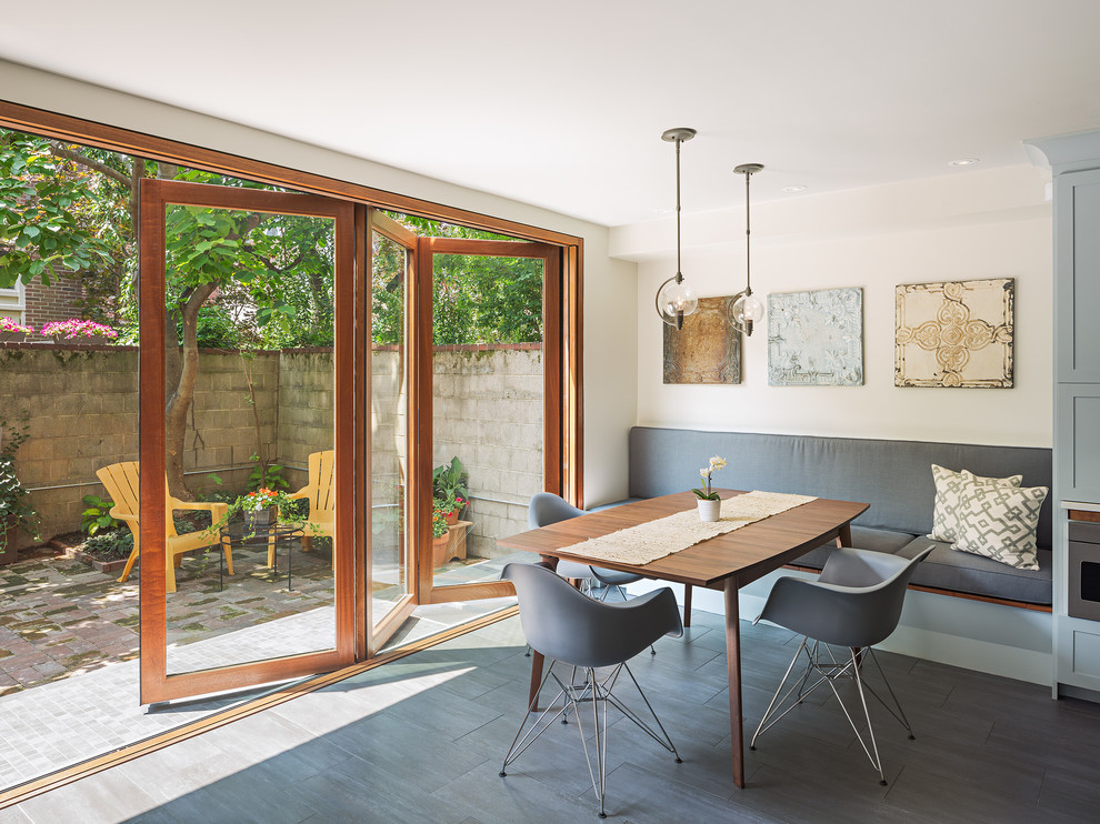 This is an example of a contemporary dining room in Philadelphia with white walls and no fireplace.