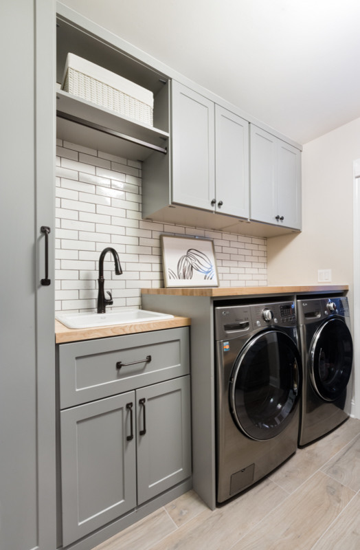 Design ideas for a mid-sized modern laundry room in Chicago with a single-bowl sink, shaker cabinets, grey cabinets, wood benchtops, beige walls, ceramic floors, a side-by-side washer and dryer and beige benchtop.