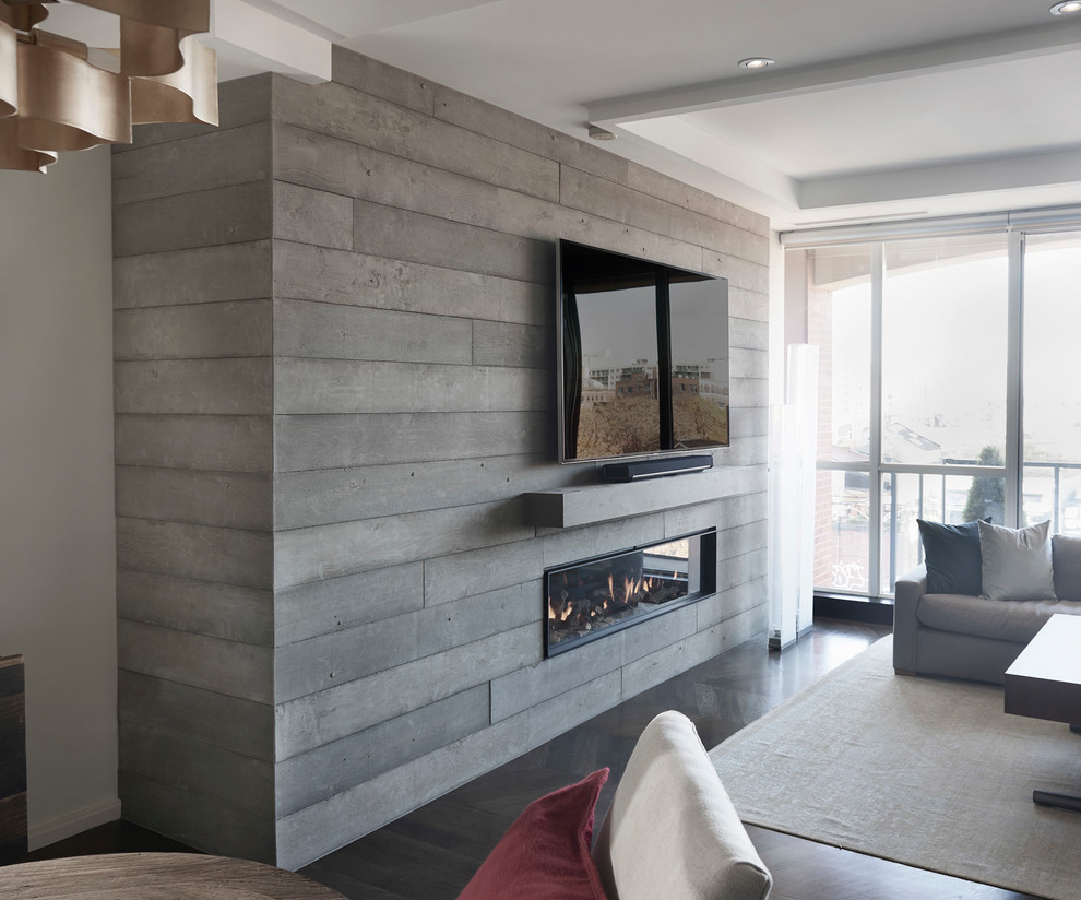 Inspiration for a mid-sized contemporary open concept living room in Toronto with white walls, dark hardwood floors, a standard fireplace, a concrete fireplace surround, a freestanding tv and brown floor.