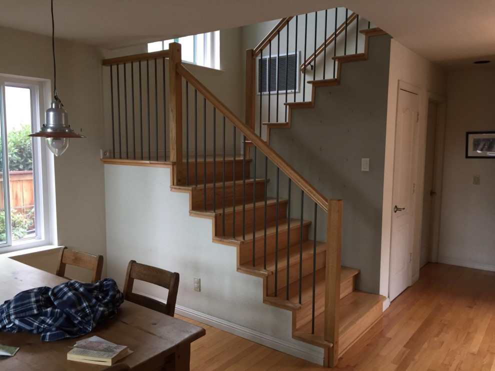 На фото: п-образная деревянная лестница среднего размера в современном стиле с деревянными ступенями и перилами из смешанных материалов с