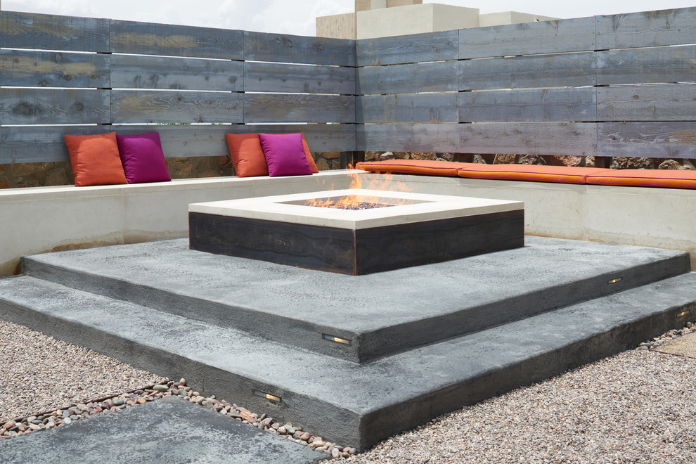 Photo of a small contemporary backyard patio in Other with a fire feature, concrete slab and no cover.