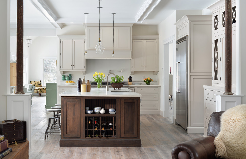 Inspiration for a mid-sized traditional l-shaped eat-in kitchen in Portland Maine with beaded inset cabinets, marble benchtops, stainless steel appliances, medium hardwood floors, with island, white benchtop and coffered.