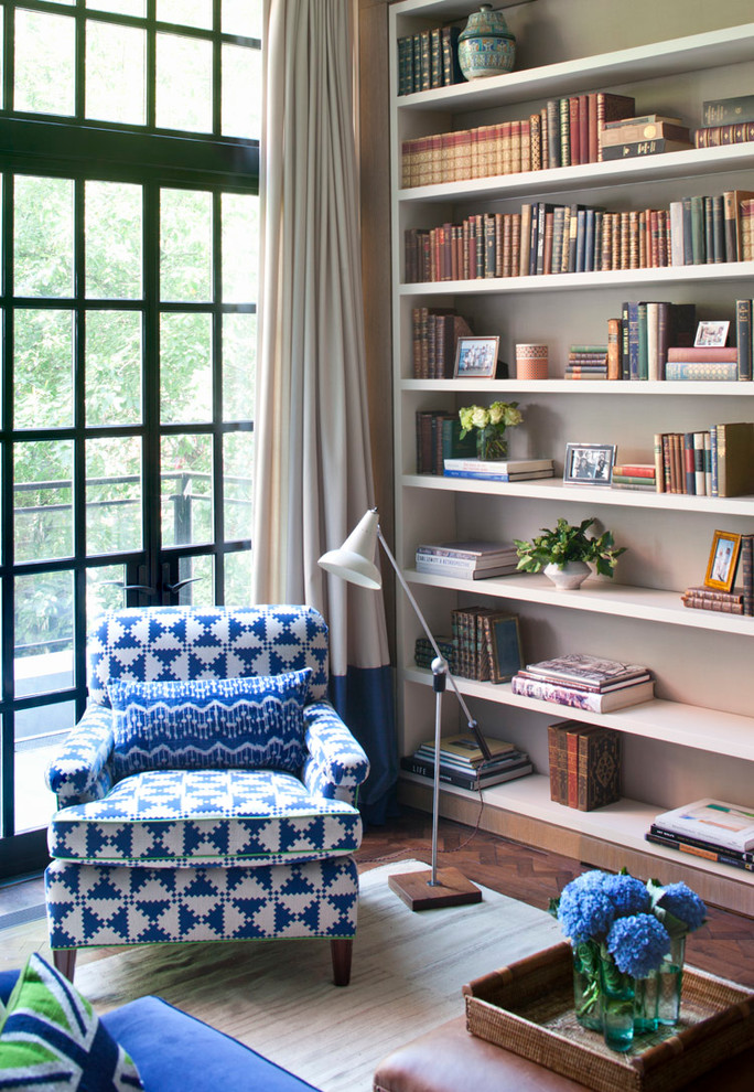 This is an example of a contemporary living room in New York with a library.