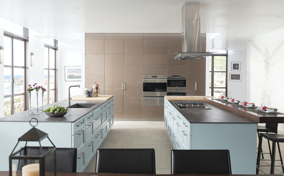 Large trendy galley porcelain tile and beige floor eat-in kitchen photo in Miami with an undermount sink, shaker cabinets, blue cabinets, soapstone countertops, stainless steel appliances and two islands