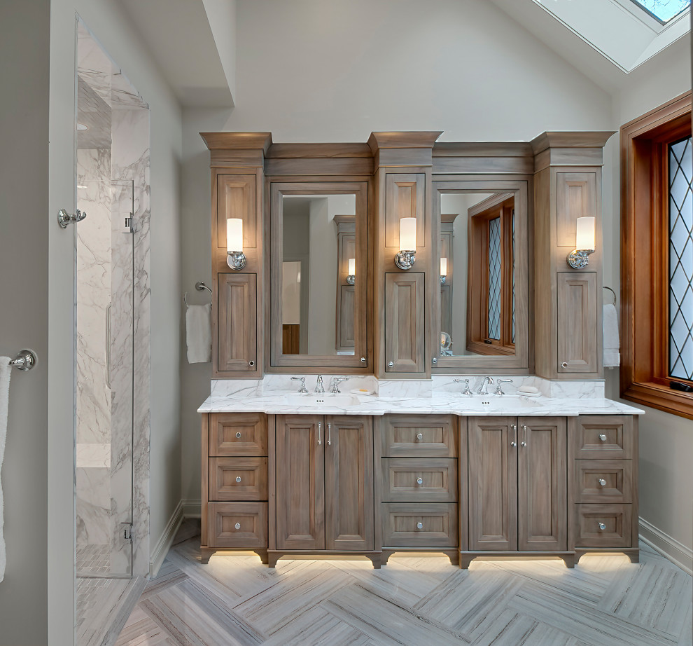 Photo of a medium sized classic ensuite bathroom in Chicago with recessed-panel cabinets, medium wood cabinets, porcelain flooring, a submerged sink, quartz worktops, grey floors, white worktops, double sinks, a built in vanity unit and a vaulted ceiling.