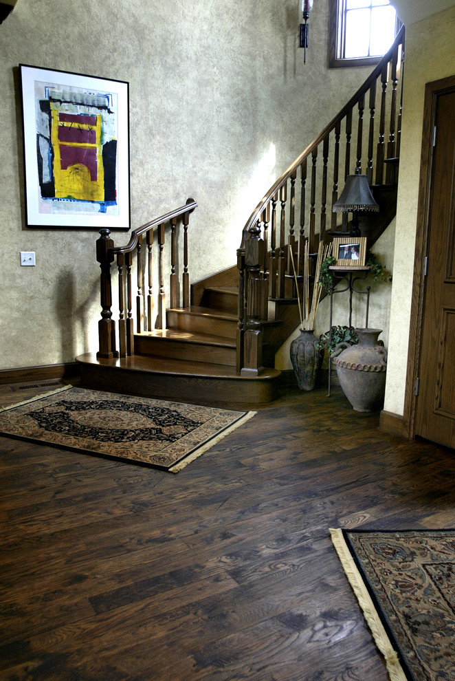 Design ideas for a mid-sized traditional wood curved staircase in Oklahoma City with wood risers and wood railing.