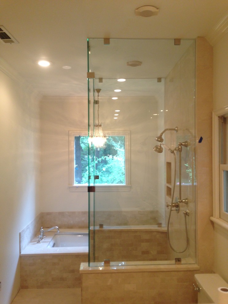 Photo of a large traditional master bathroom in Other with a corner tub, an open shower, a two-piece toilet, beige tile, ceramic tile, white walls and ceramic floors.
