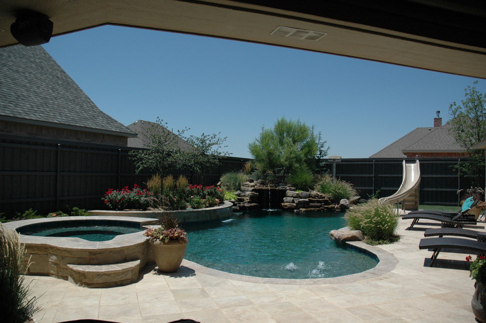 Inspiration for a large rustic backyard stone and custom-shaped natural hot tub remodel in Austin