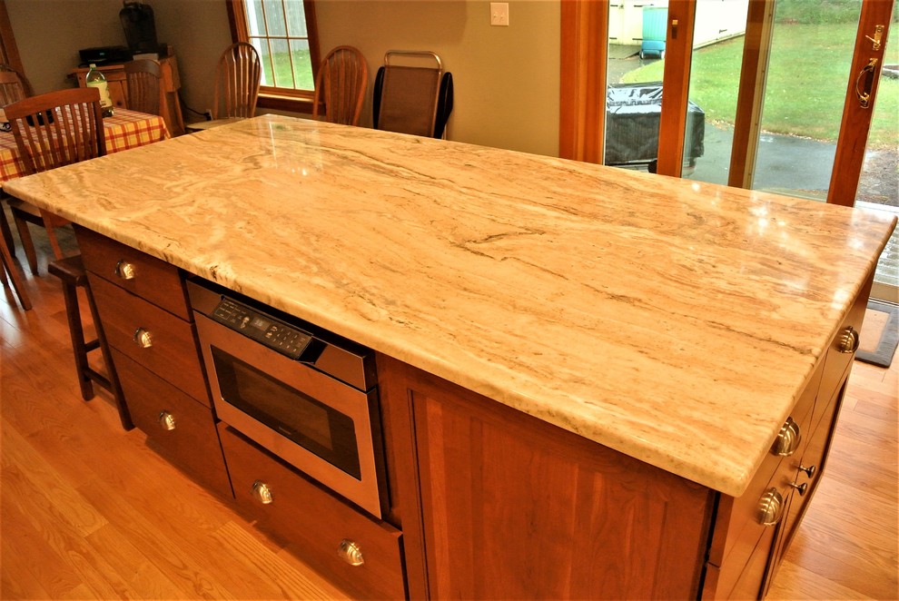 Kitchen - transitional light wood floor kitchen idea in Boston with an undermount sink, shaker cabinets, white cabinets, quartzite countertops, white backsplash, subway tile backsplash, stainless steel appliances and an island