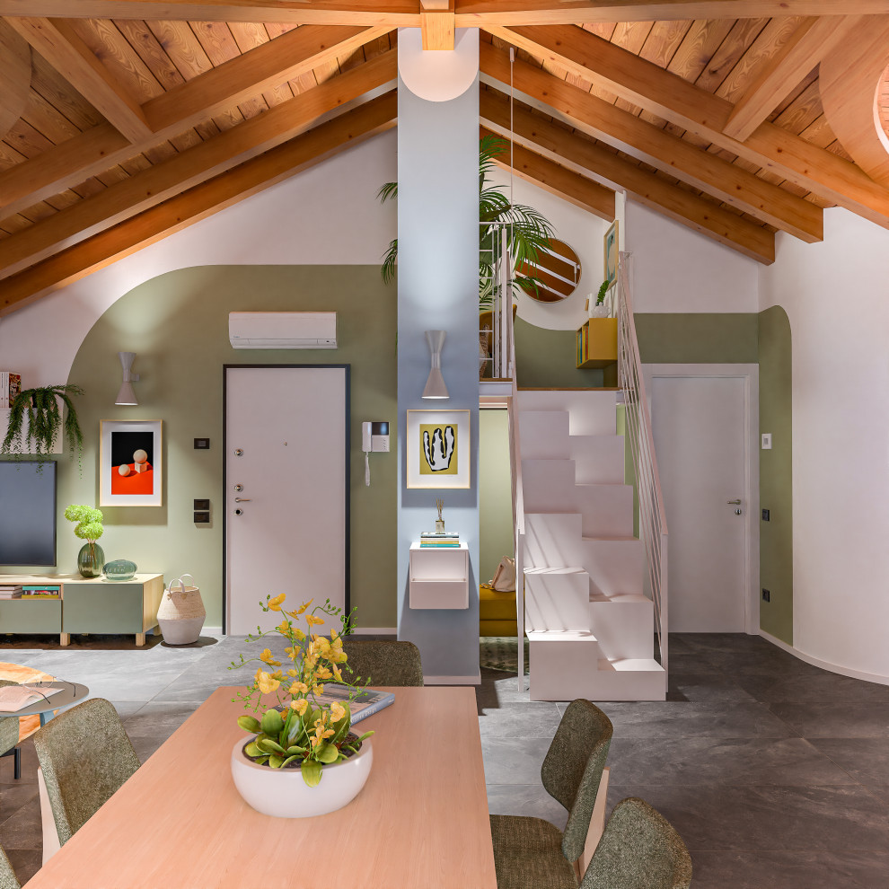 Photo of a large contemporary mezzanine living room in Milan with a reading nook, multi-coloured walls, porcelain flooring, a wall mounted tv, grey floors and exposed beams.