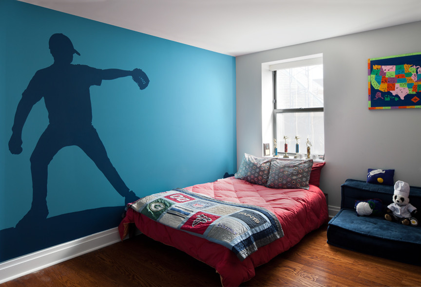Photo of a mid-sized transitional kids' bedroom for kids 4-10 years old and boys in New York with blue walls and medium hardwood floors.