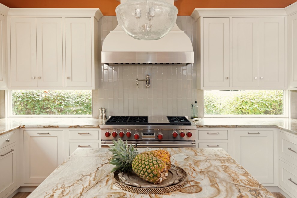 Mid-sized transitional u-shaped light wood floor and beige floor open concept kitchen photo with an undermount sink, recessed-panel cabinets, gray cabinets, granite countertops, stainless steel appliances, an island, white backsplash and glass tile backsplash