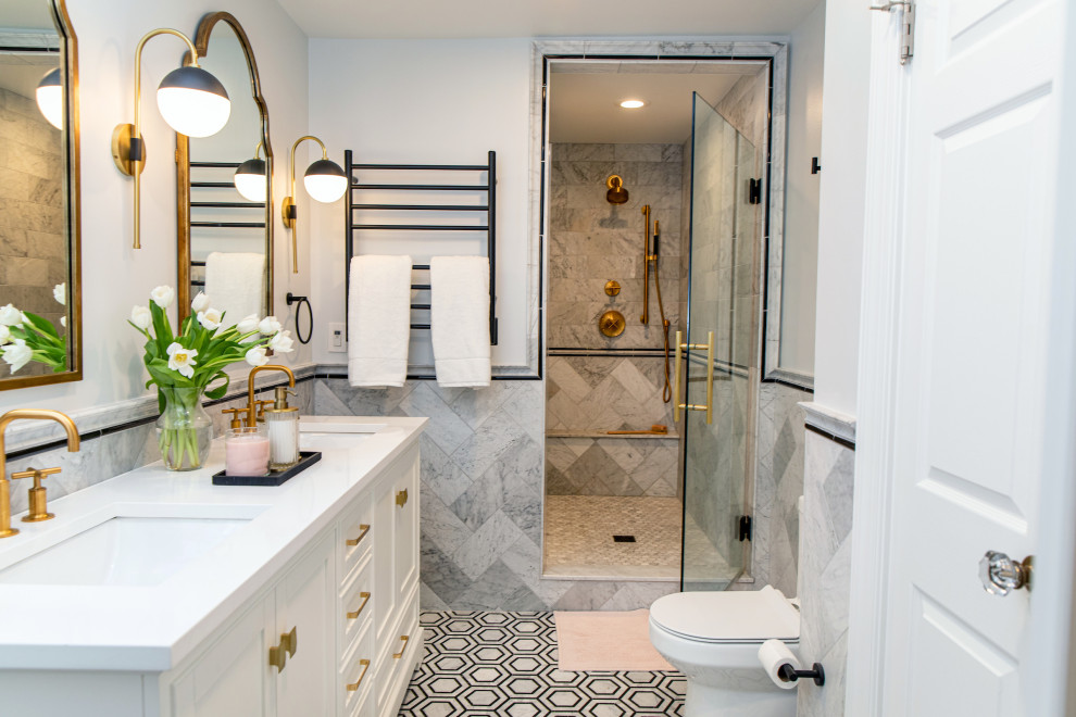 This is an example of a traditional master bathroom in Baltimore with beaded inset cabinets, white cabinets, an alcove shower, marble, marble floors, a hinged shower door, white benchtops, a shower seat, a double vanity, a freestanding vanity and decorative wall panelling.