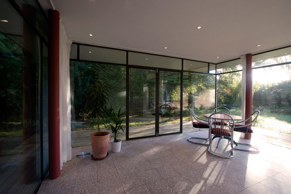 Photo of a mid-sized contemporary sunroom in West Midlands with ceramic floors, a standard ceiling and white floor.