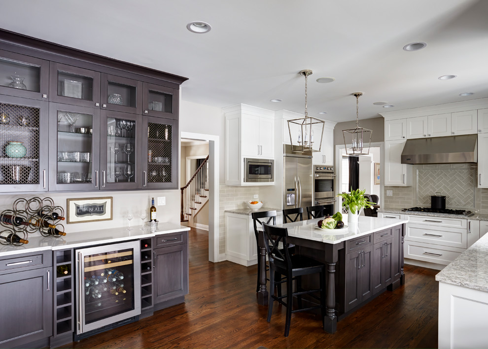 Open concept kitchen - large transitional u-shaped medium tone wood floor open concept kitchen idea in Chicago with a double-bowl sink, flat-panel cabinets, white cabinets, quartz countertops, beige backsplash, subway tile backsplash, stainless steel appliances and an island