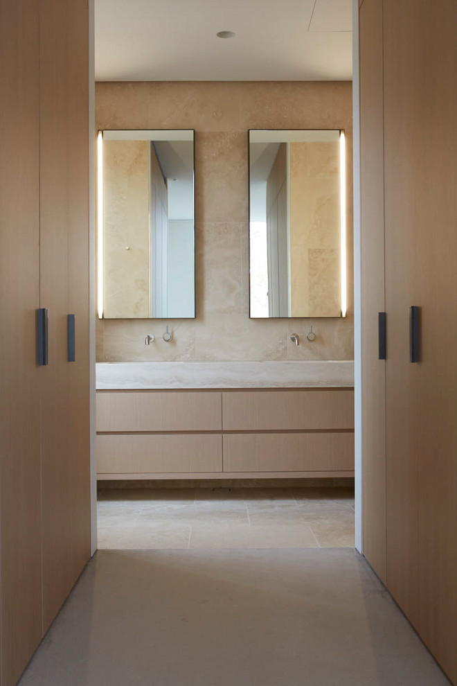 Photo of a contemporary bathroom in Melbourne with flat-panel cabinets, light wood cabinets, beige walls, white floor and beige benchtops.