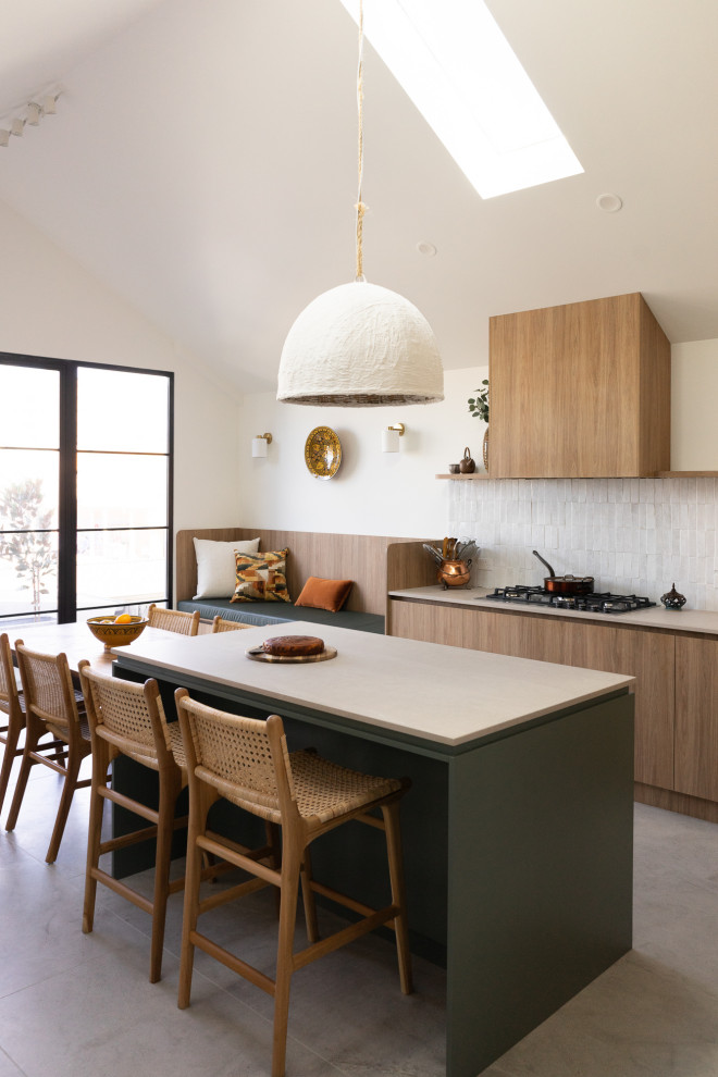 Inspiration for a mid-sized modern eat-in kitchen in Melbourne with an undermount sink, flat-panel cabinets, green cabinets, ceramic splashback, stainless steel appliances, porcelain floors, grey floor, grey benchtop and vaulted.